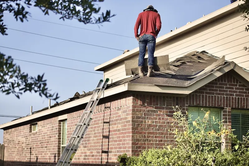 Professional roofer working on a residential roof in Kraft Corner